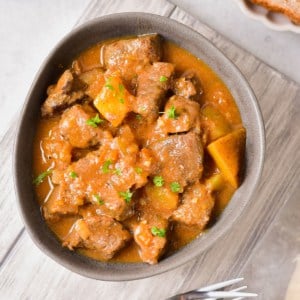 The completed recipe in a bowl with fresh herbs.