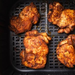 The completed air fryer boneless chicken thighs recipe in the air fryer basket.