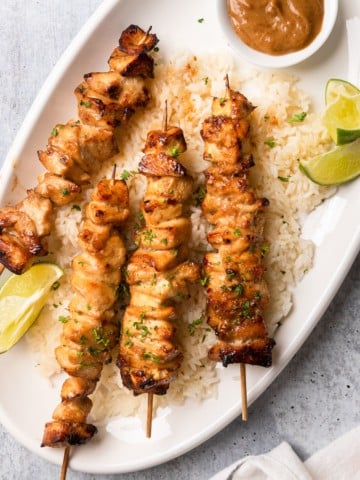 The completed Chinese chicken on a stick recipe on a platter with jasmine rice.