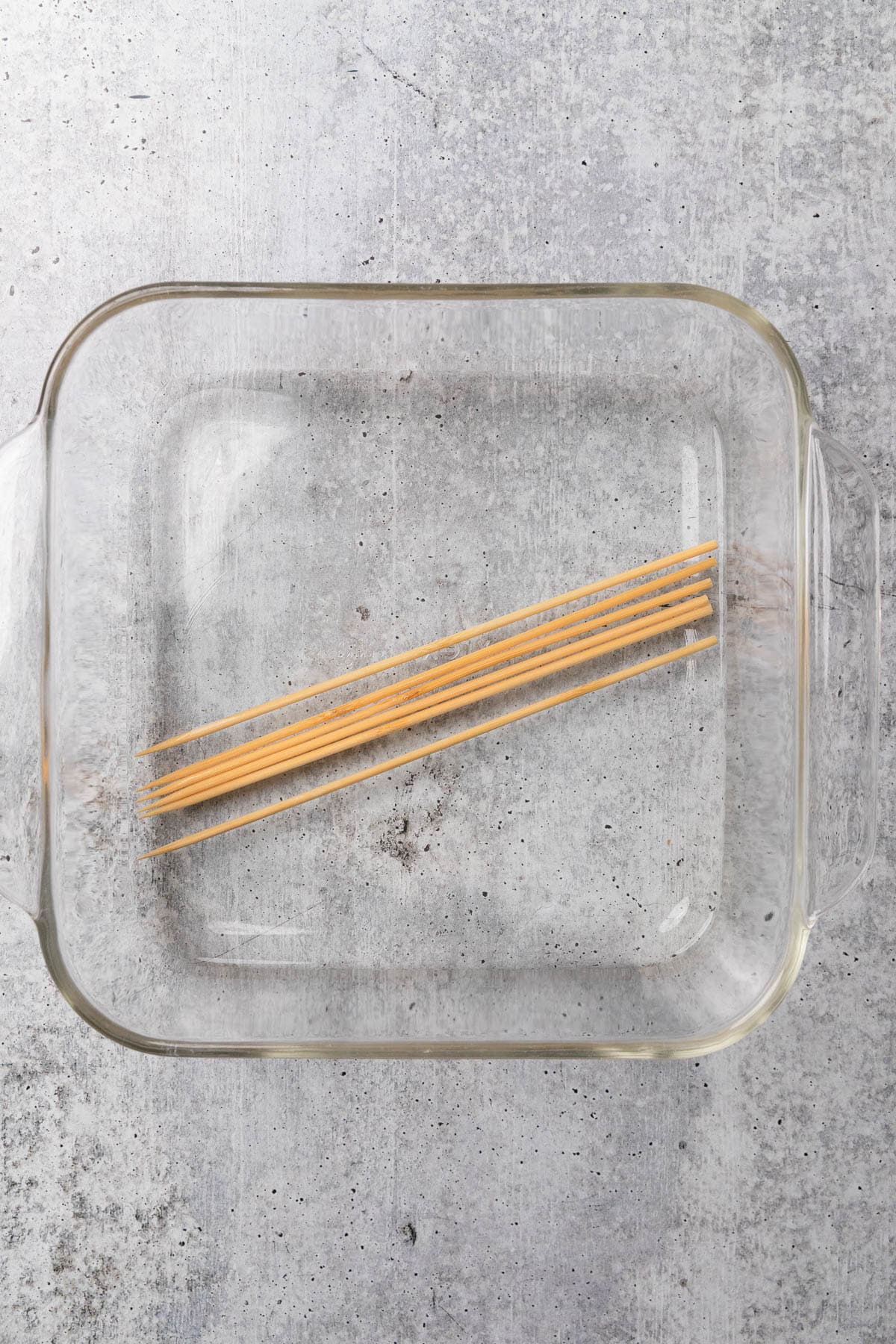 Soaking wooden skewers in water.