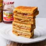 Air fryer pbj halves stacked on a plate.