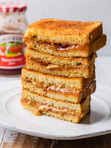 Air fryer pbj halves stacked on a plate.