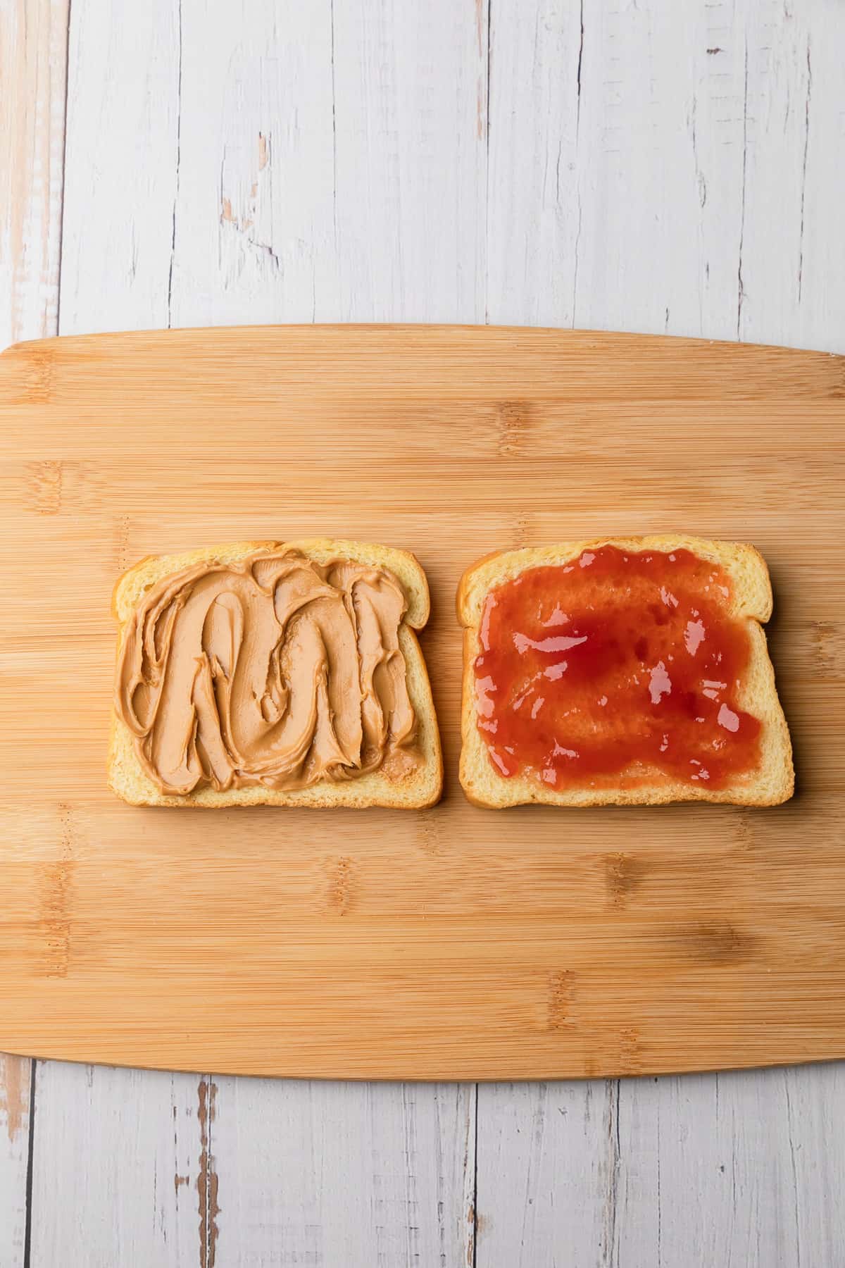 Making the pbj on a cutting board.