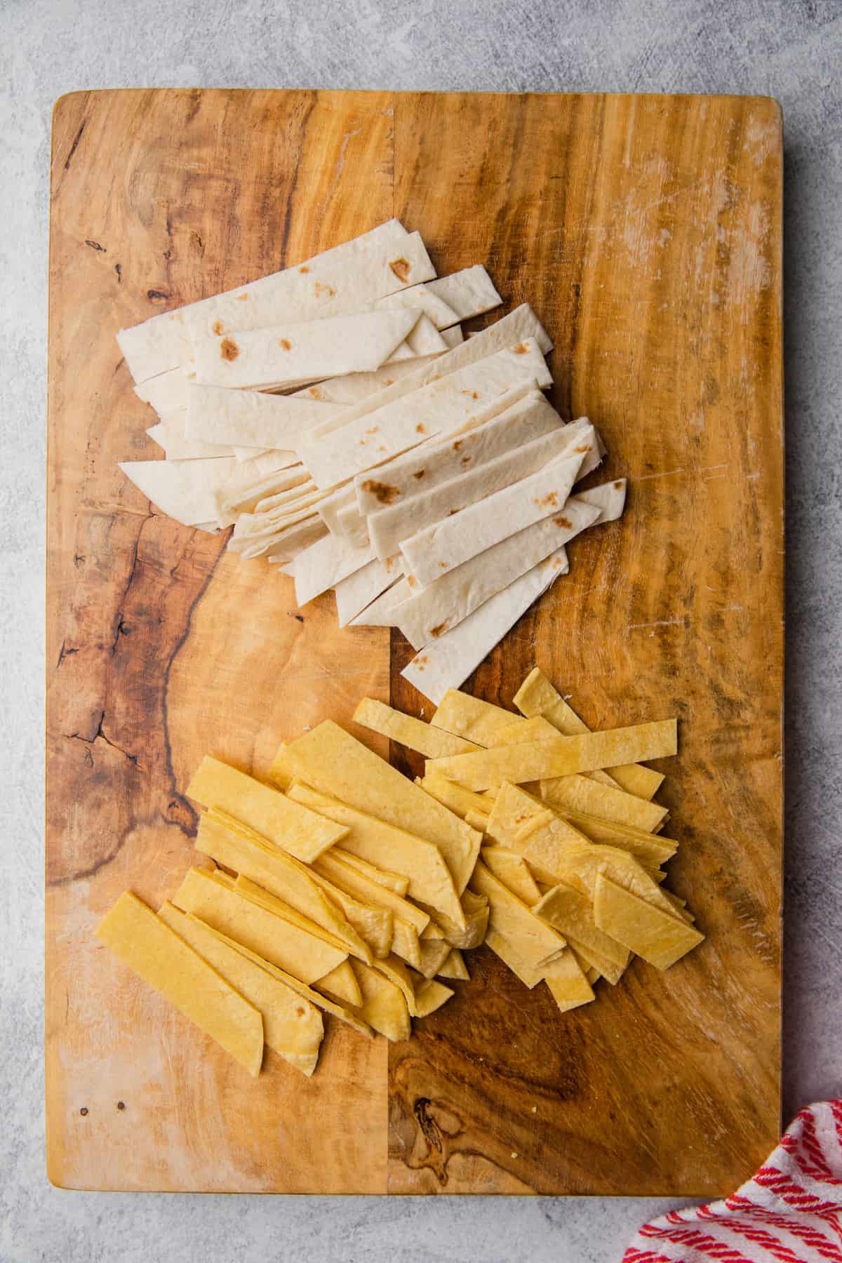 Tortillas cut into strips on a cutting board.