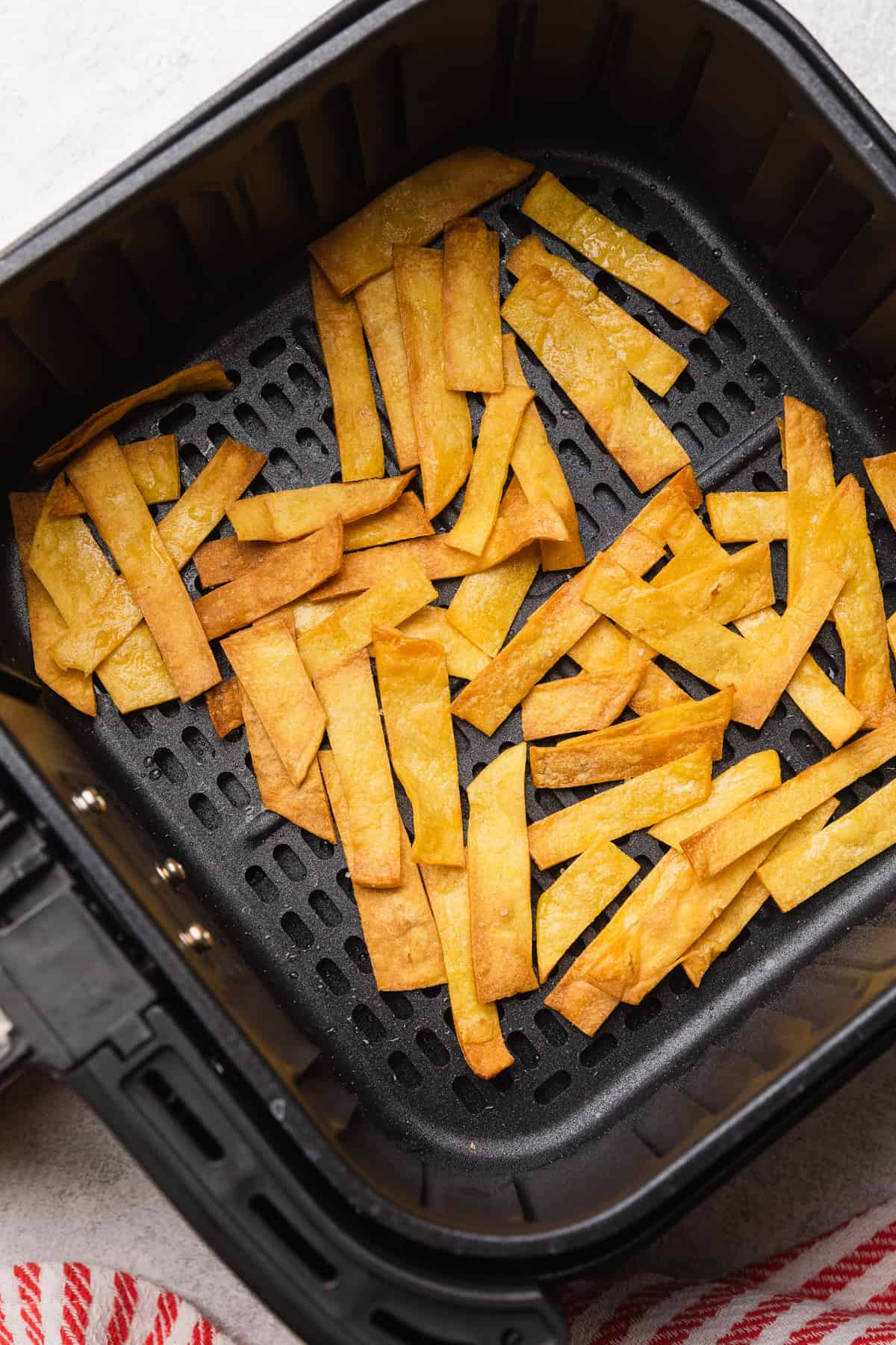 Corn tortilla strips cooked to a light golden brown.