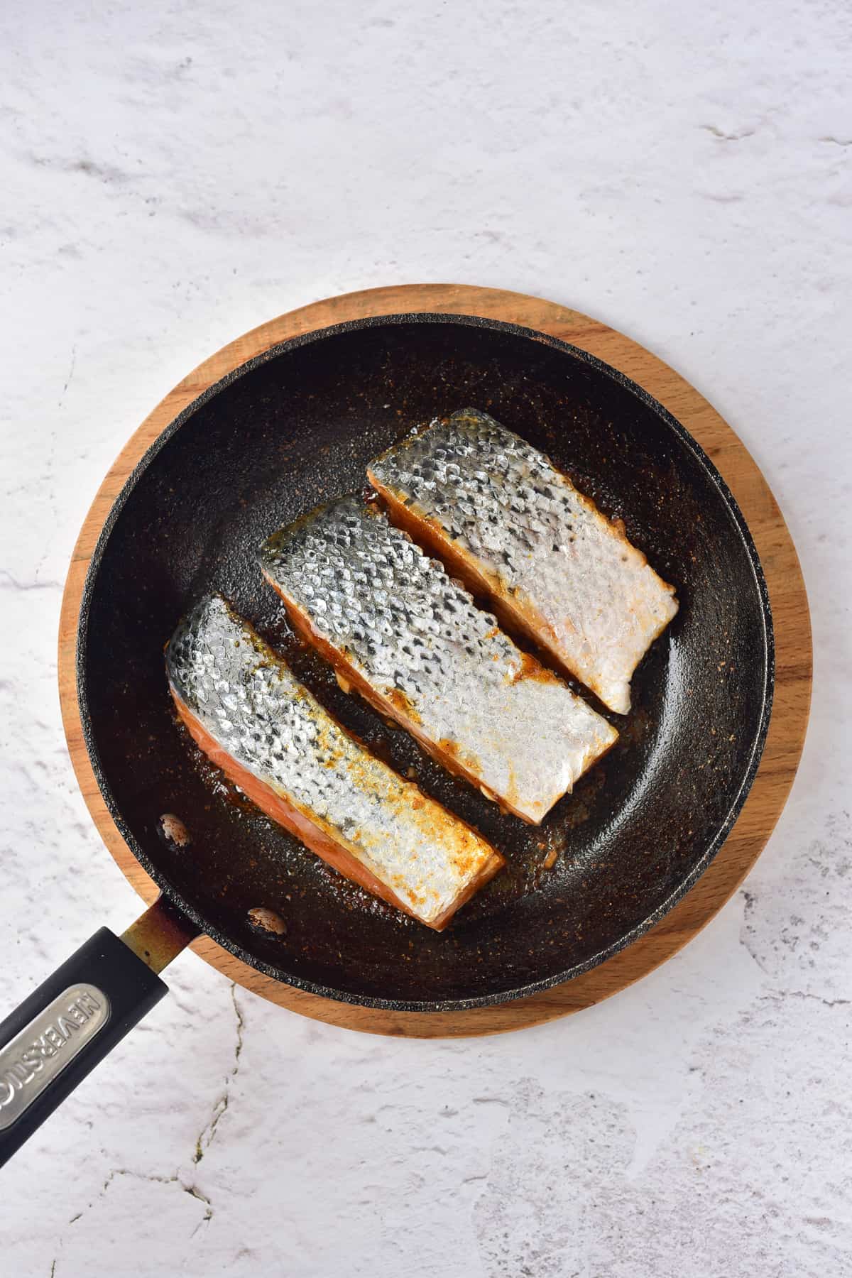 Cooking salmon filets in a fry pan.