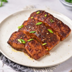 Marinated salmon completed and served on a plate.