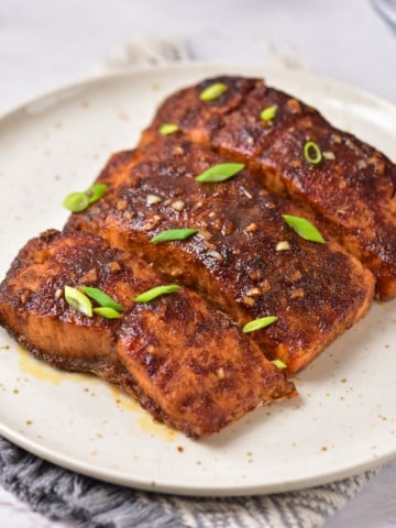 Marinated salmon completed and served on a plate.