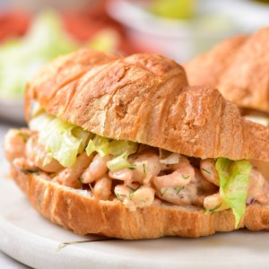 A completed shrimp salad served on a croissant.