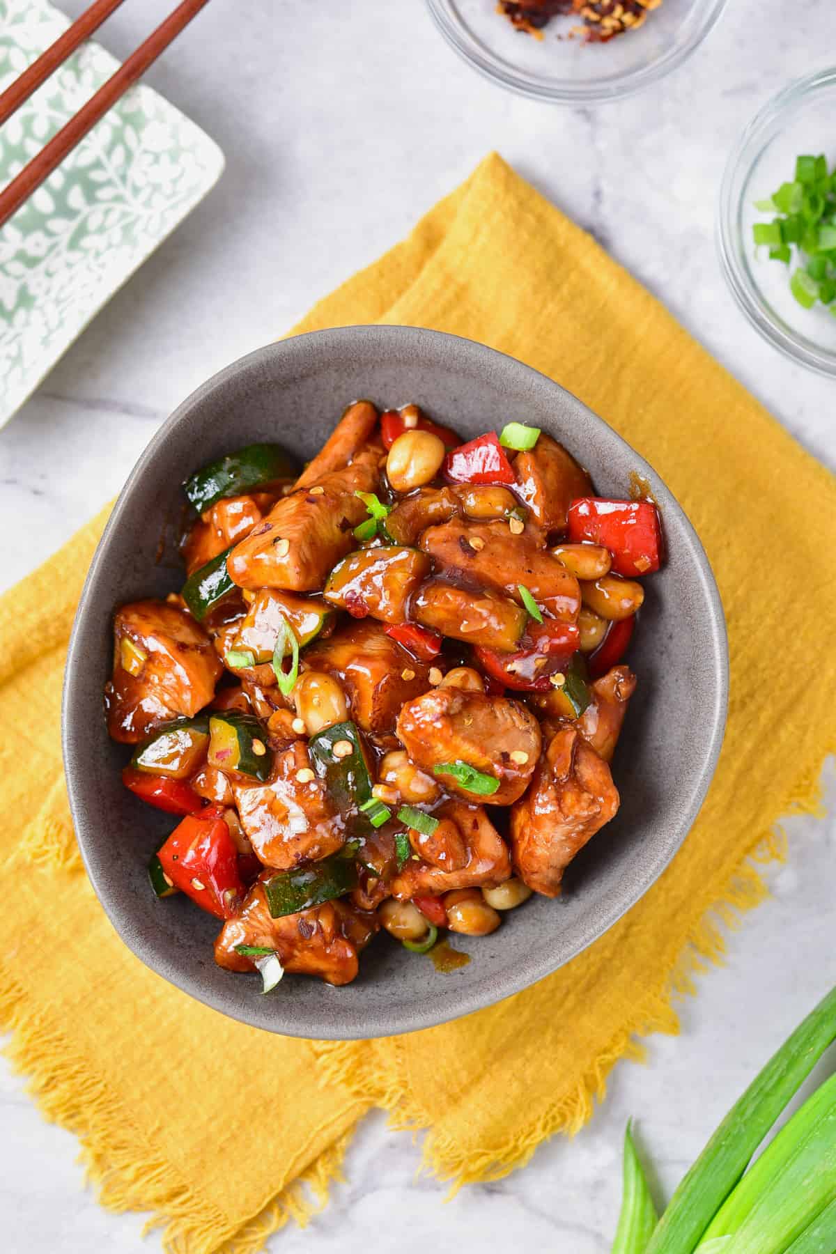 a bowl of kung pao chicken on a yellow napkin.