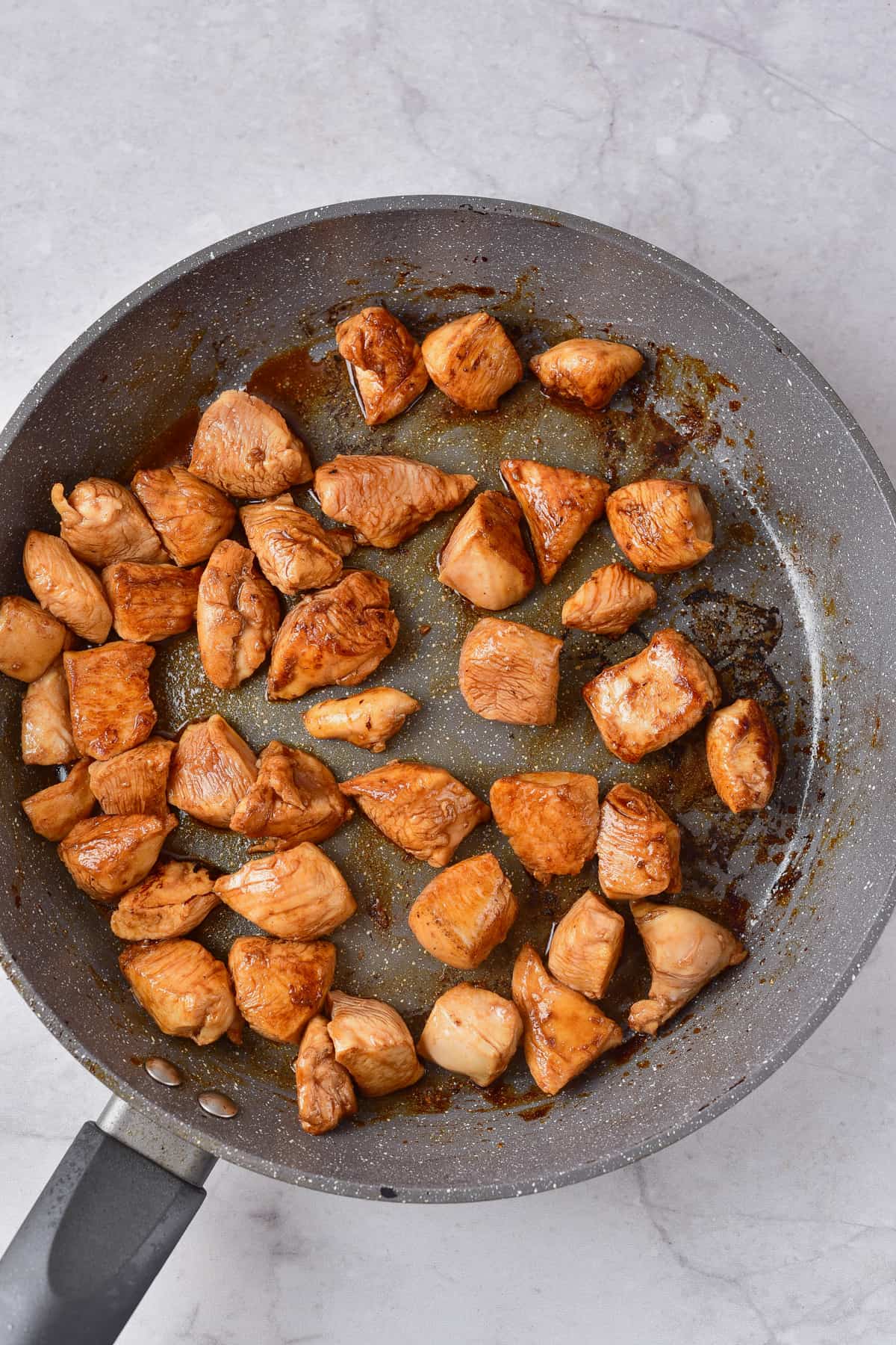 Cooking chicken in a pan.