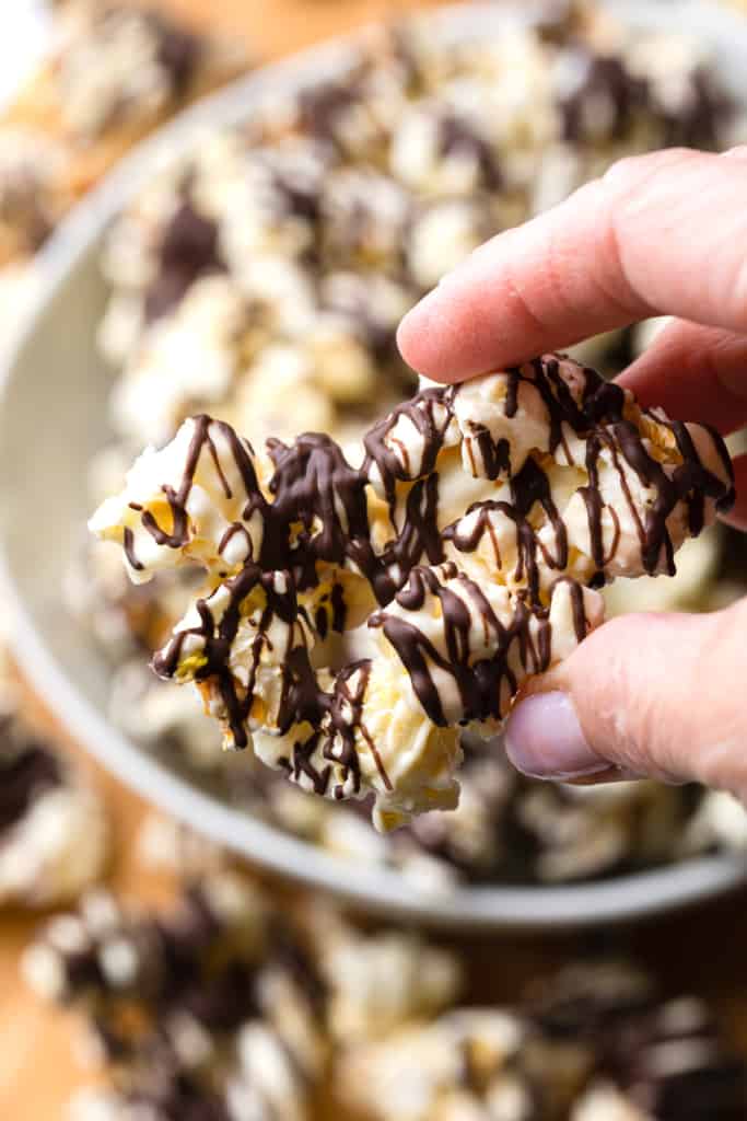 A piece of chocolate drizzled popcorn.