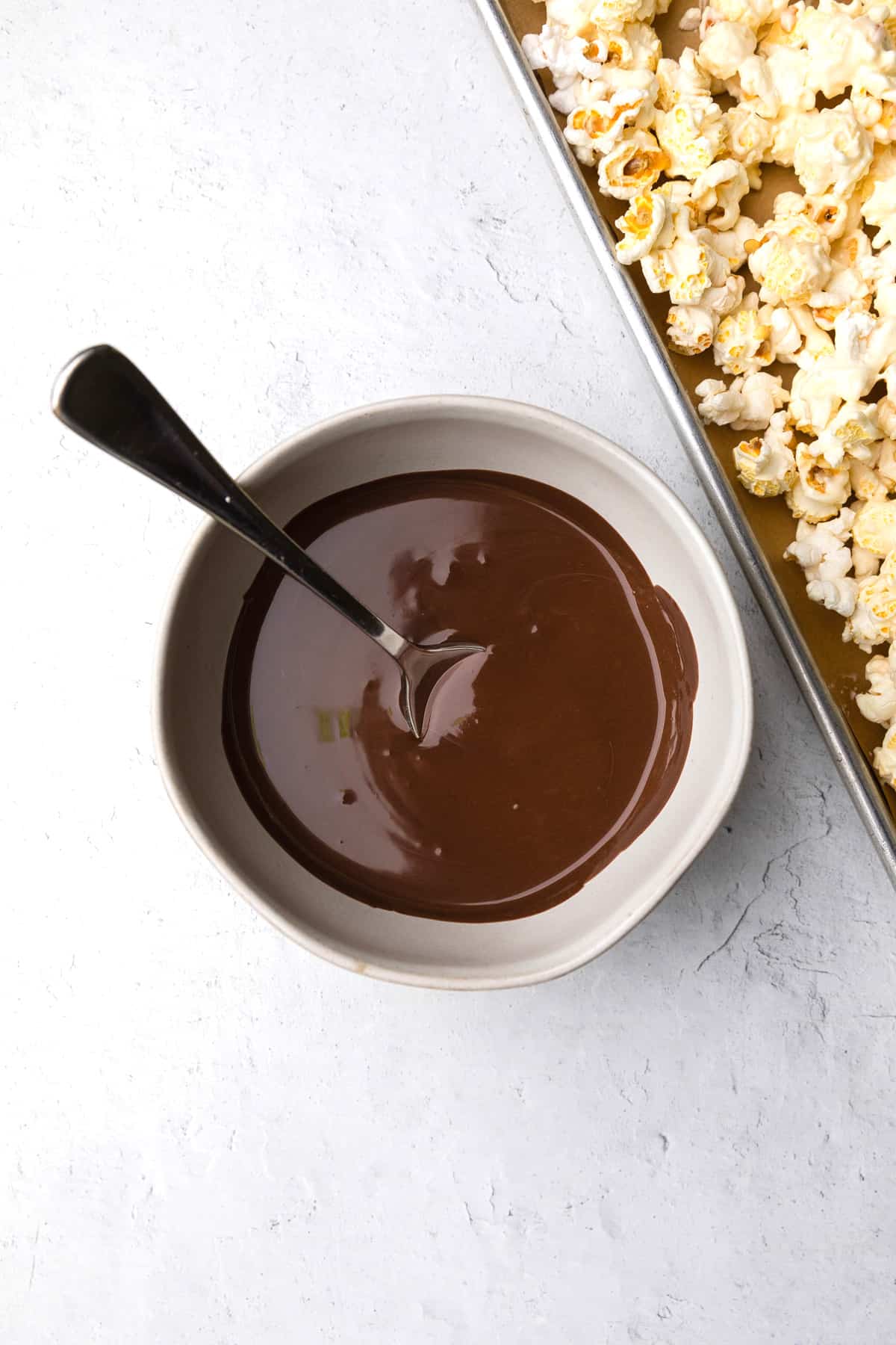 Melted chocolate in a bowl with a spoon.