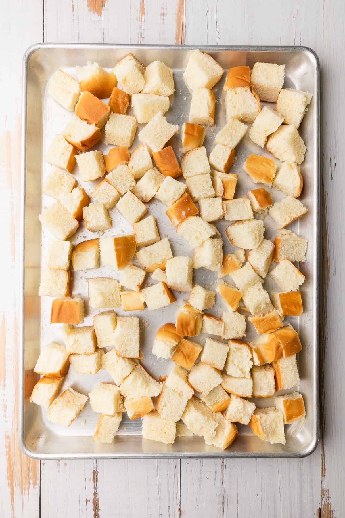 Cubed bread on a sheet pan.