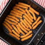 Tyson anytizers chicken fries in an air fryer basket.