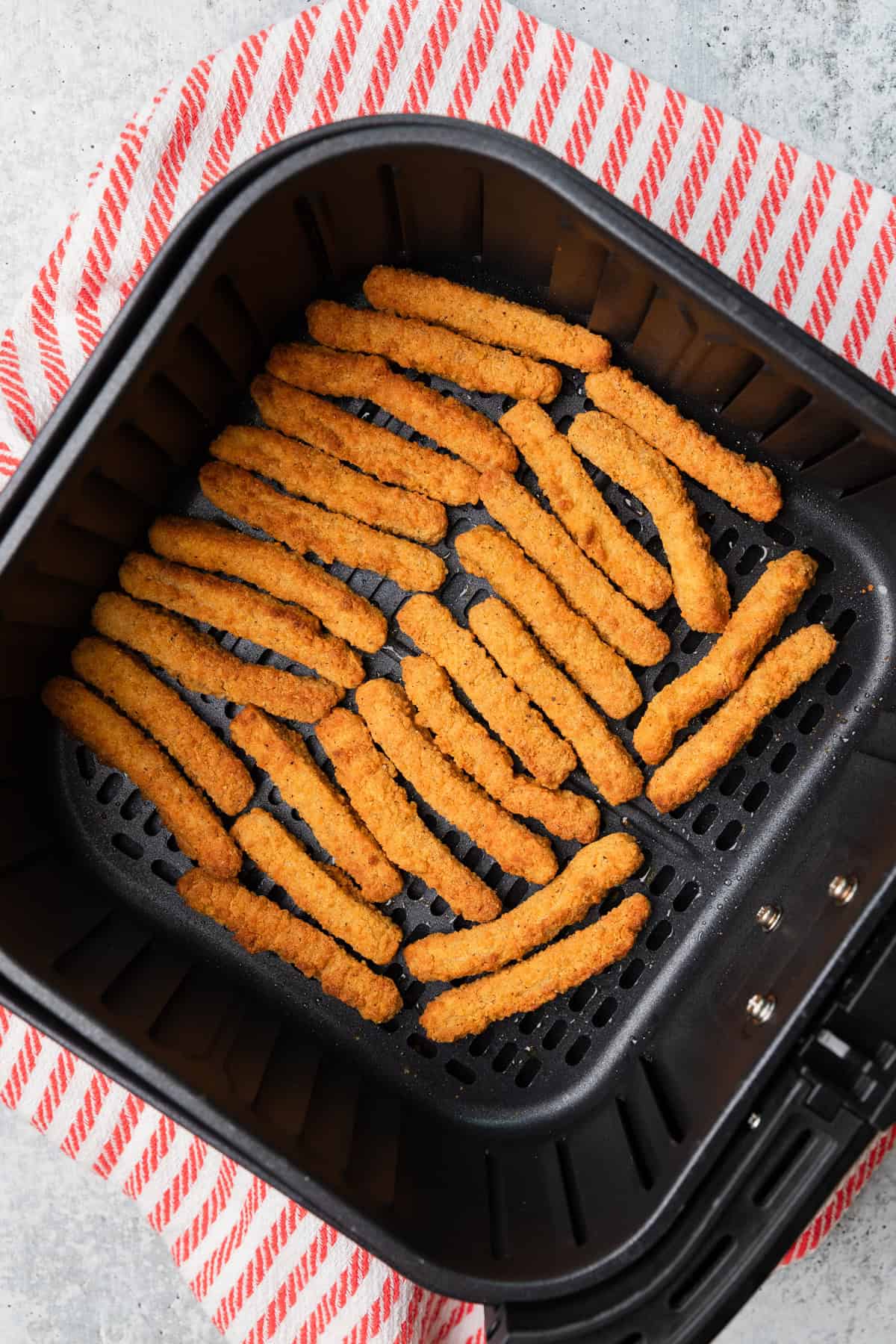 Cooked chicken fries in the air fry basket.