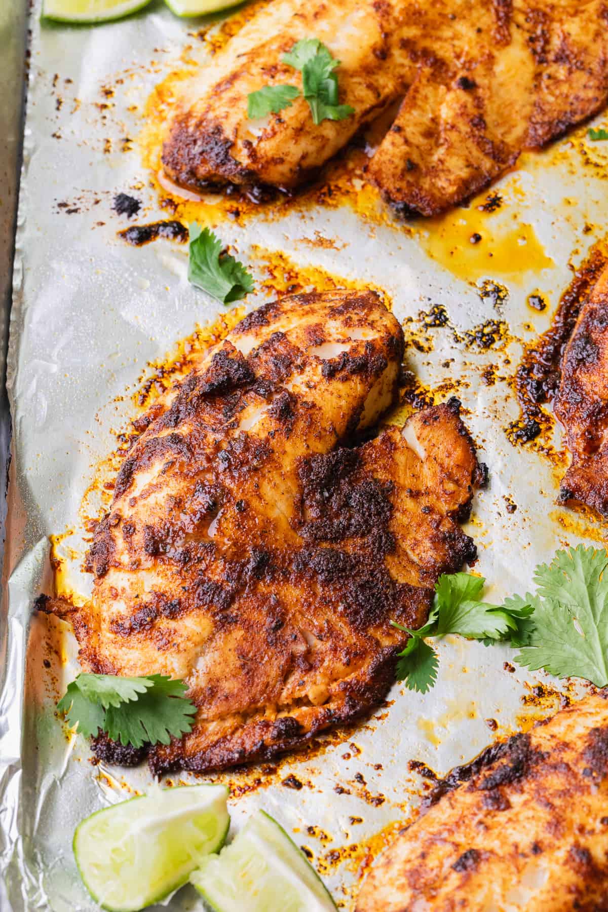 Blackened baked tilapia on a sheet pan.