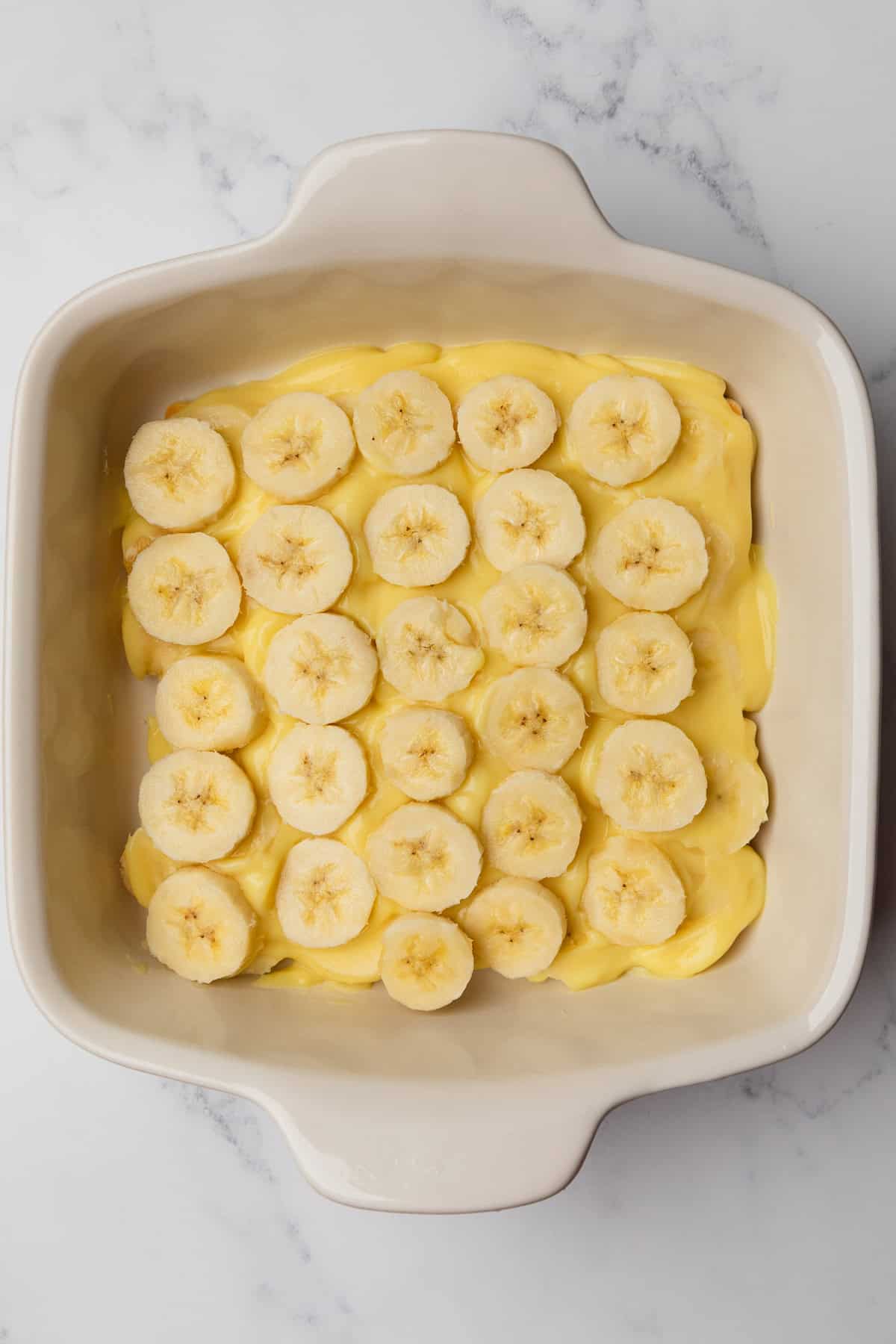 Bananas layered over pudding layer.