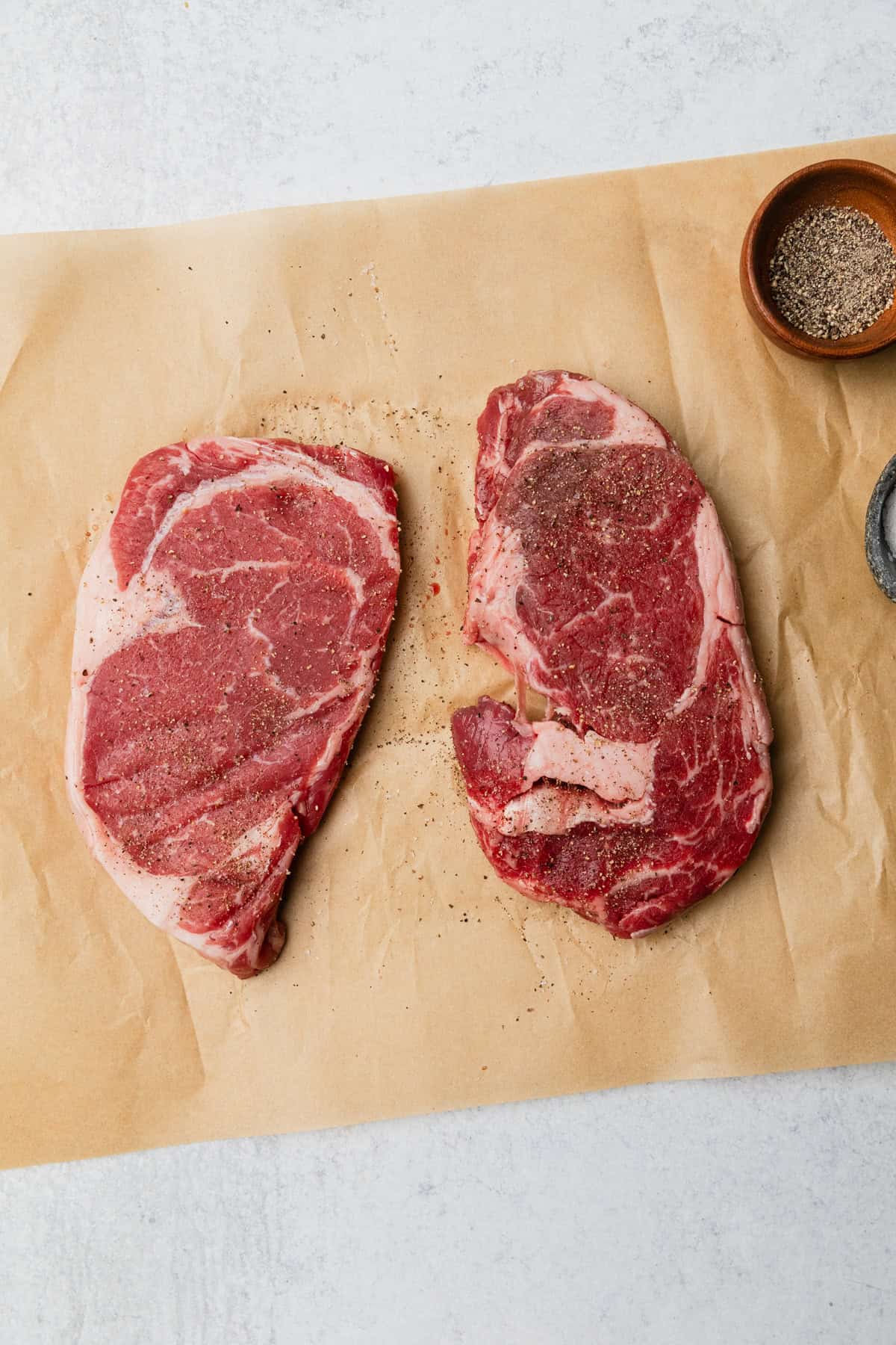 ribeyes at room temperature on a counter.