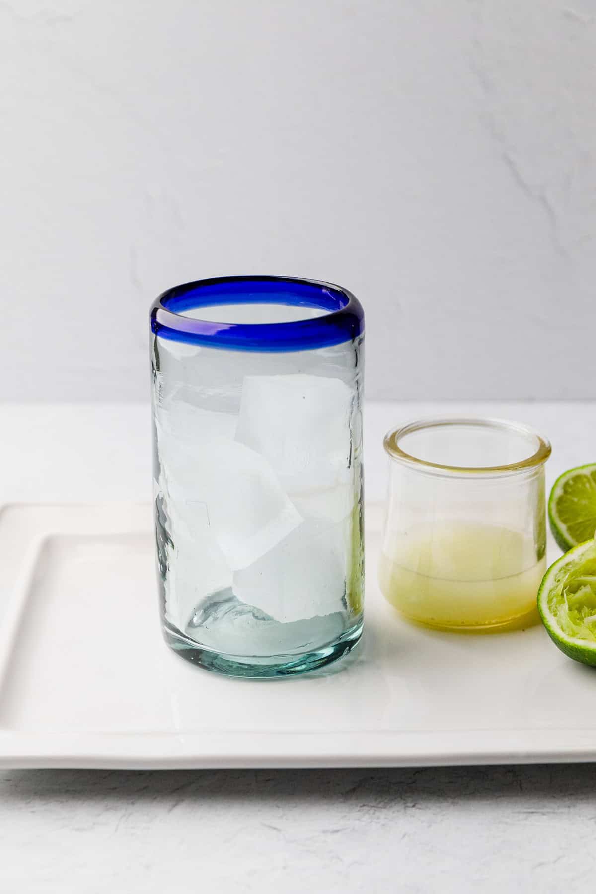 Add ice to high ball glass.