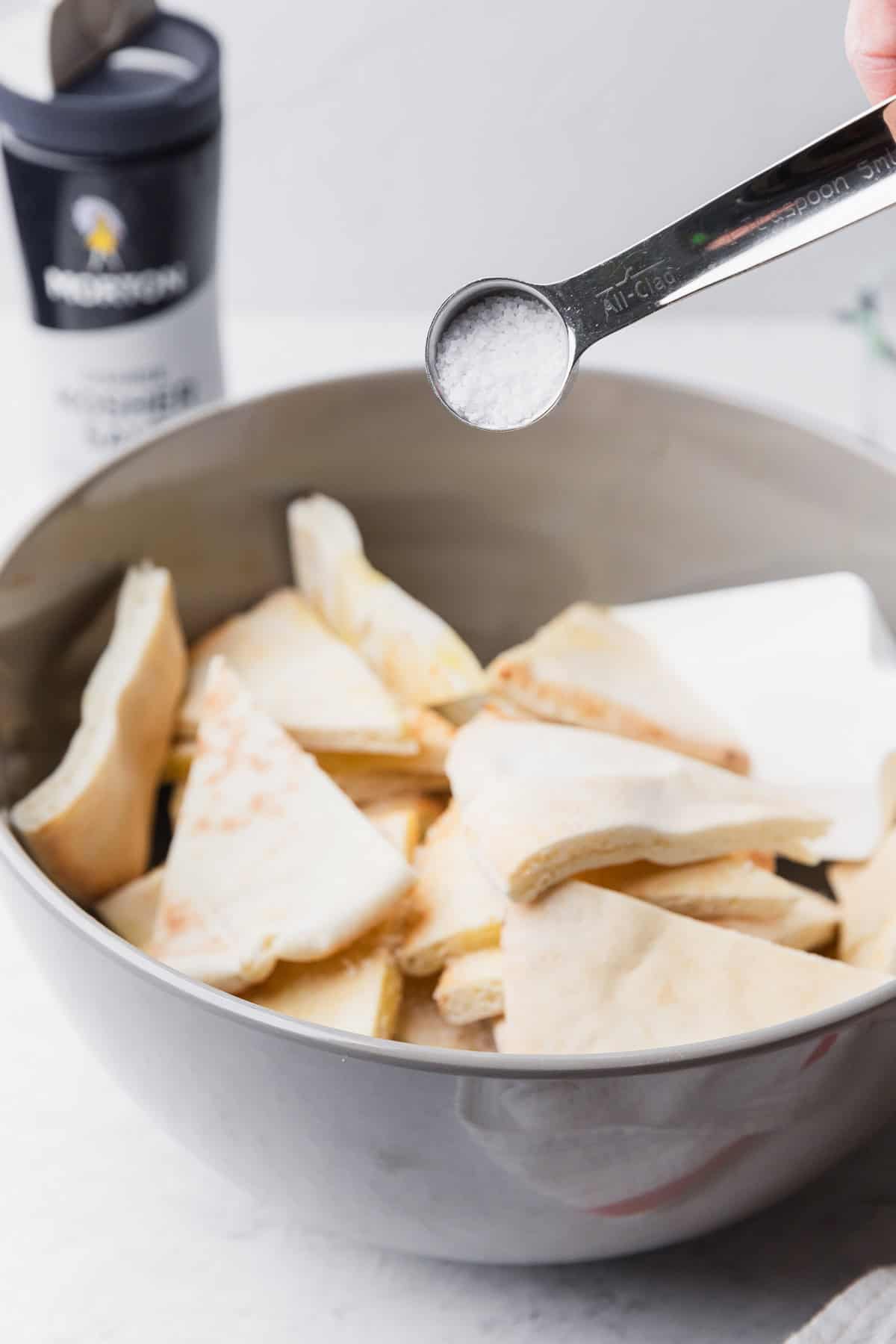 Adding salt to pita breads.