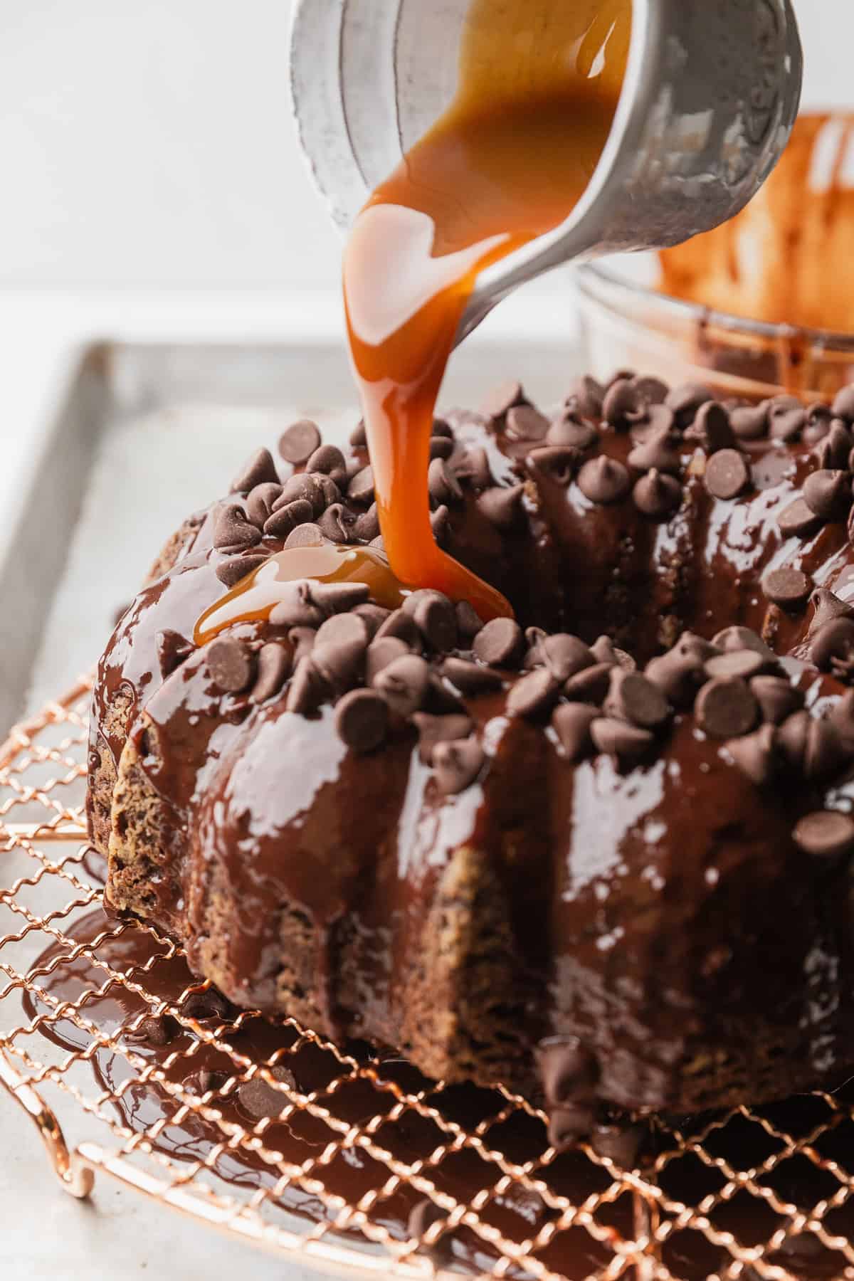 Pouring caramel sauce over cake.