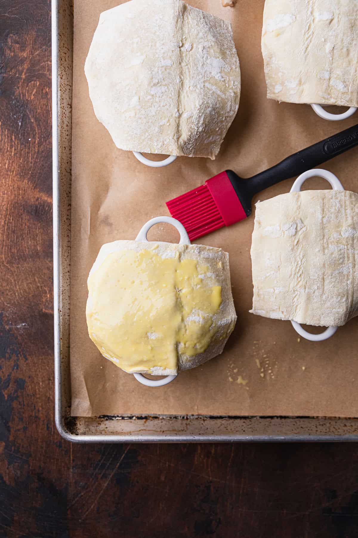Brushing on an egg wash over the puff pastry.
