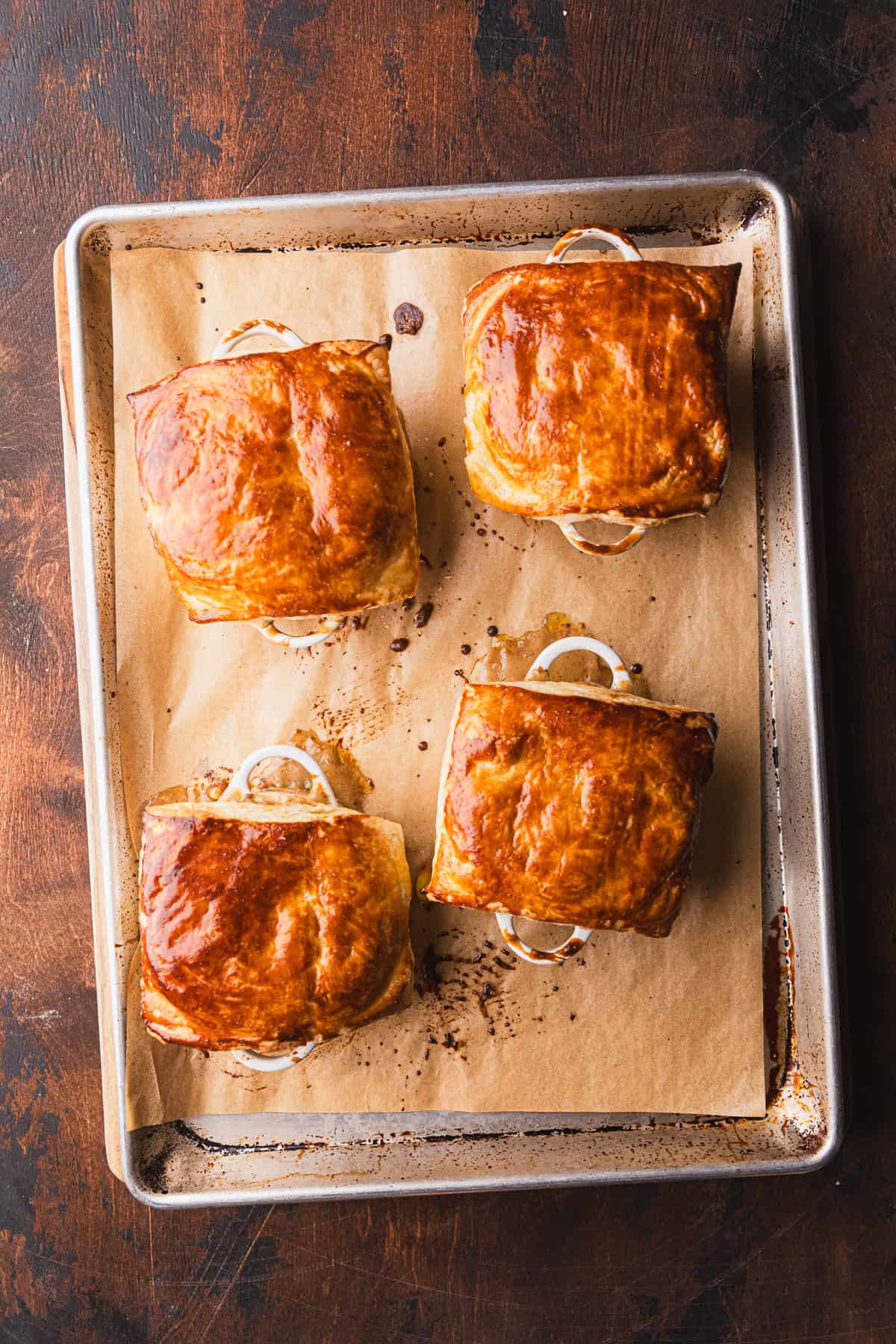 The baked beef pot pies on a sheet pan.