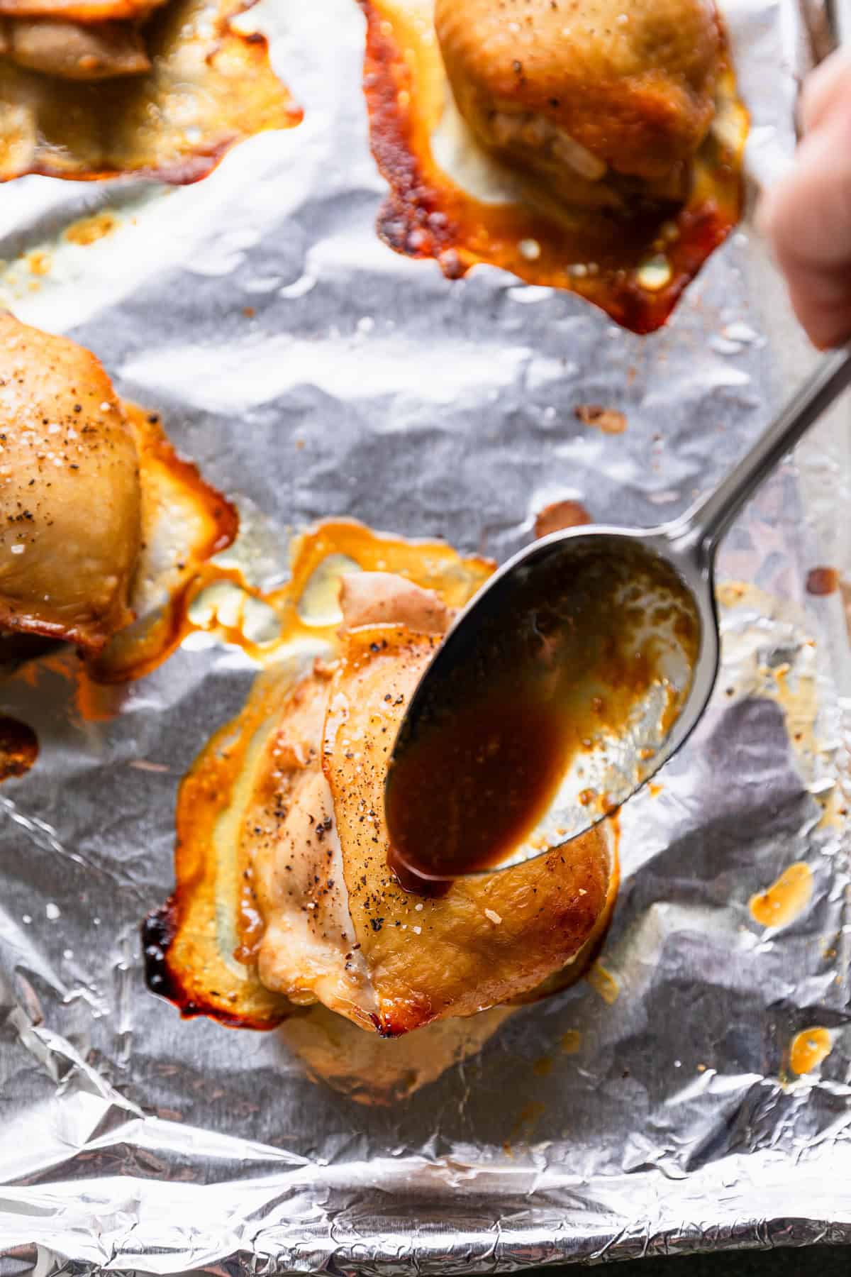 Basting partially cooked chicken.