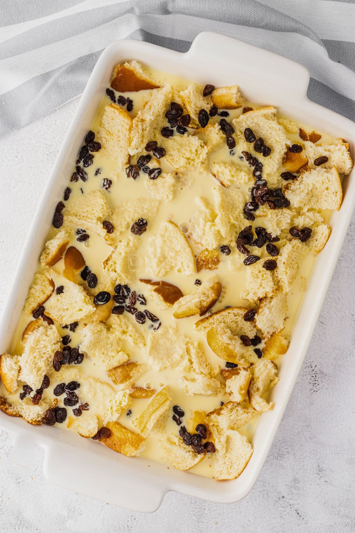 Adding the custard layer to the casserole dish.