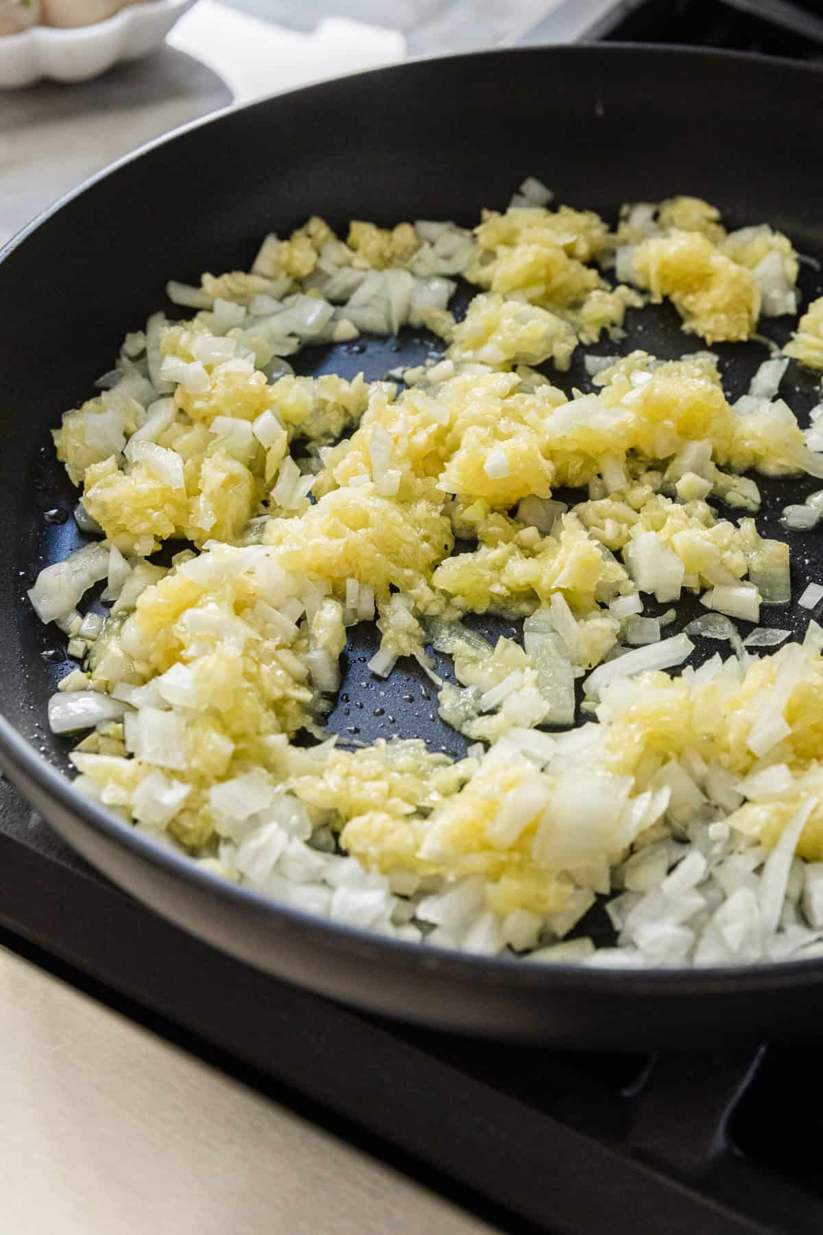Cooking onions and zucchini pulp in a skillet.