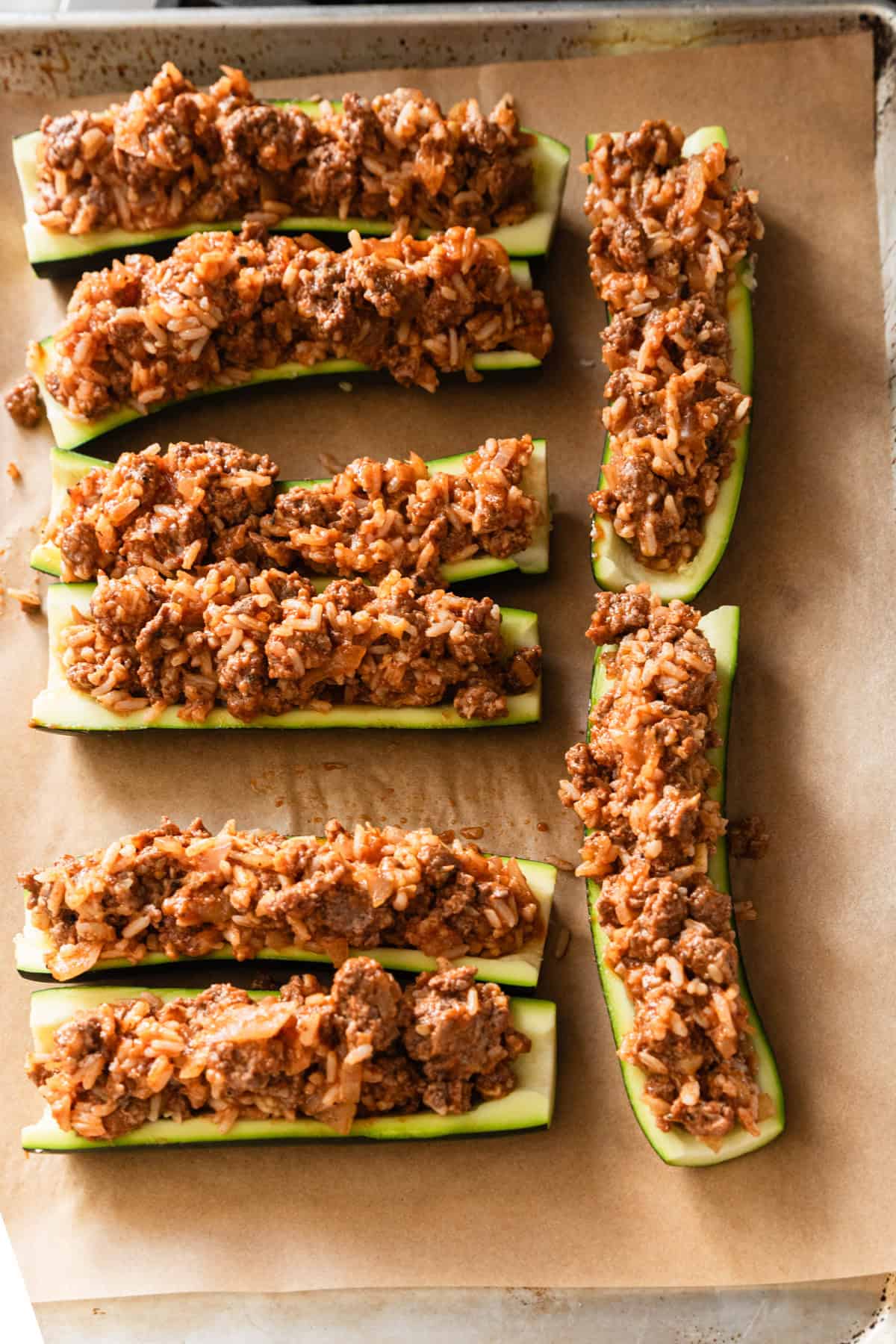 Stuffing the zucchini with the meat mixture.