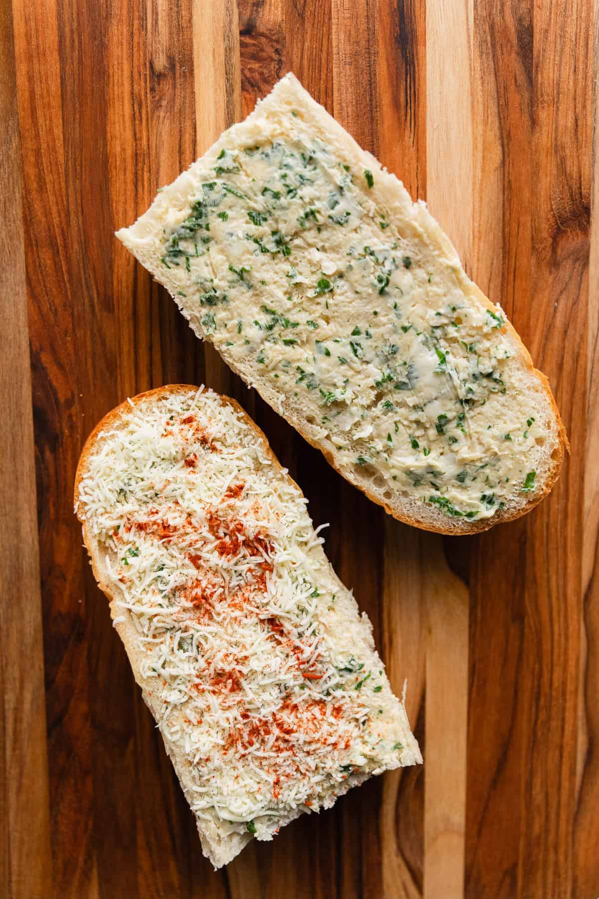 Spreading garlic butter on bread slices.