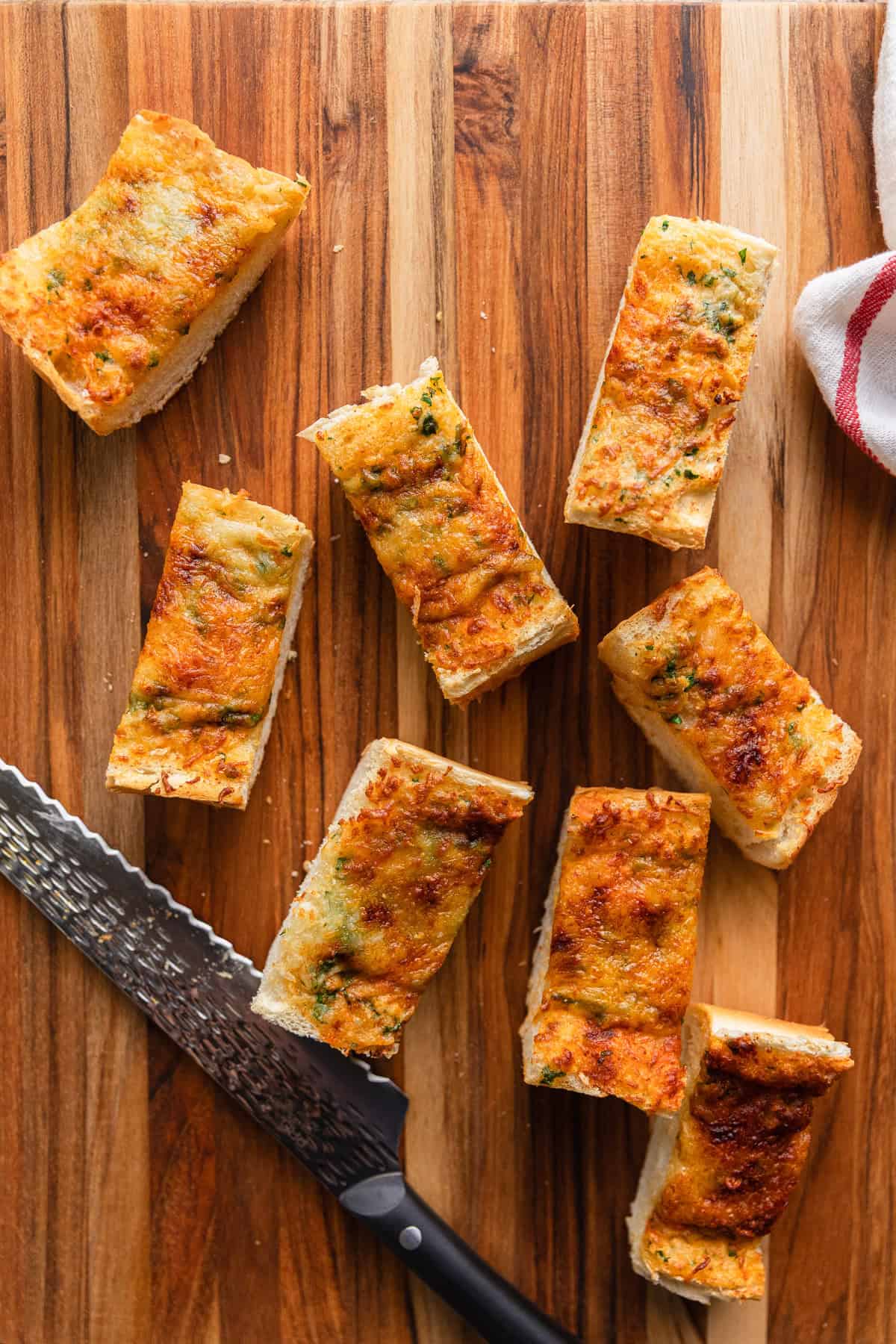 Slices of garlic bread on a cutting board.