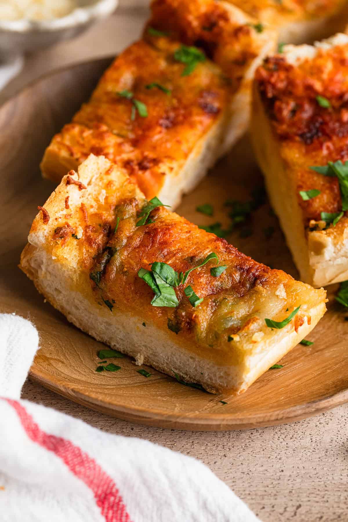 Air fryer garlic bread sliced on a plate.