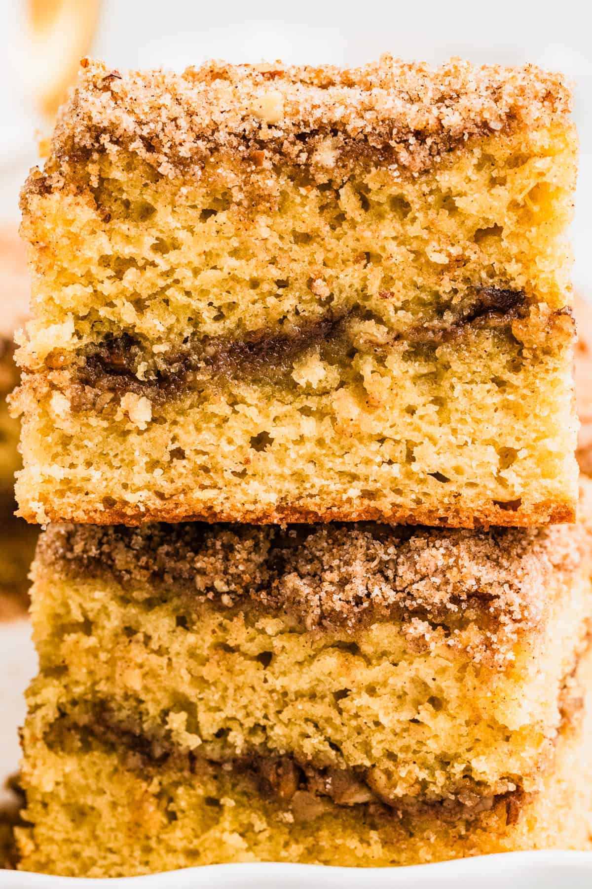 A stack of three pieces of cinnamon coffee cake.