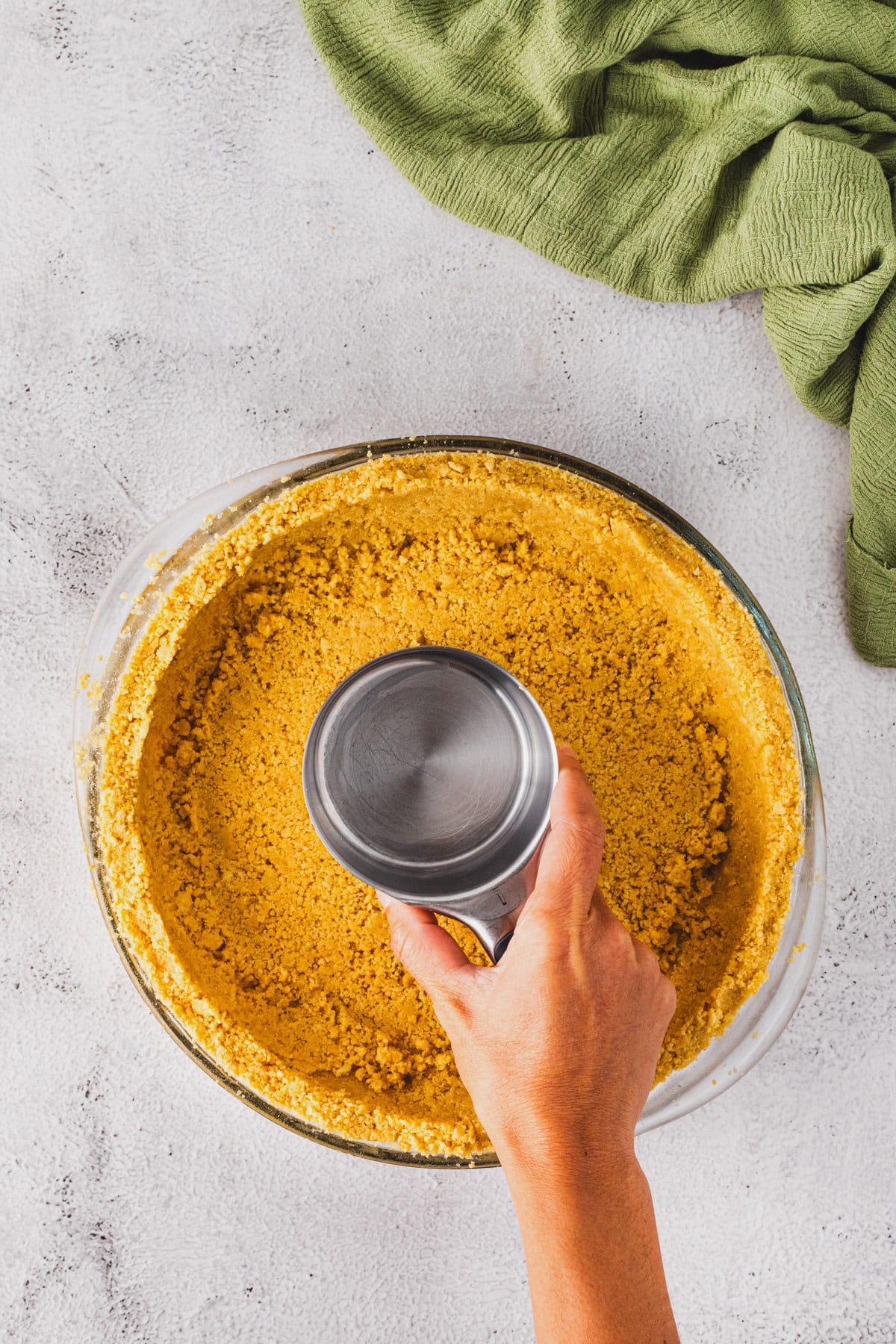 Presssing oreo crust into pie plate.