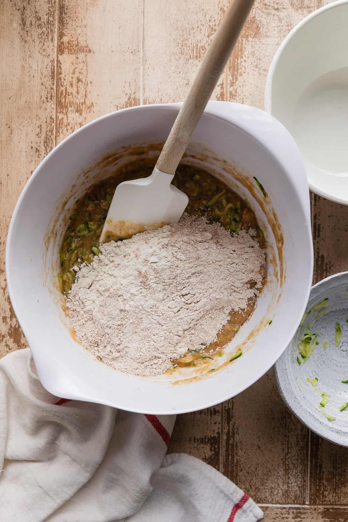 Adding the remaining dry ingredients to the batter.
