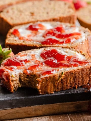 Zucchini banana bread with butter and jam.
