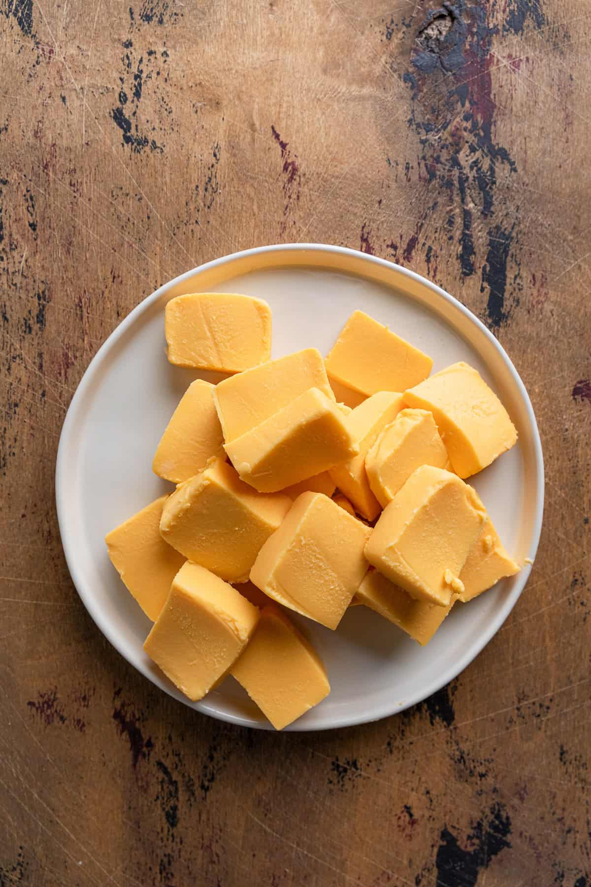 Cut up pieces of velveeta cheese.