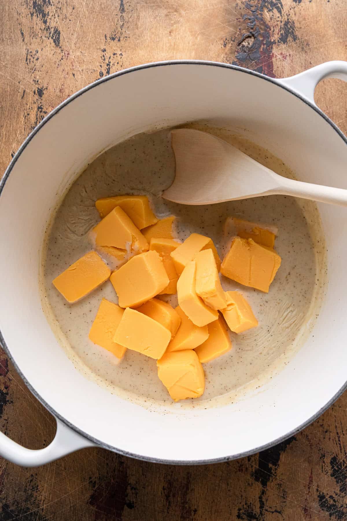 Adding velveeta to make the cheese sauce.
