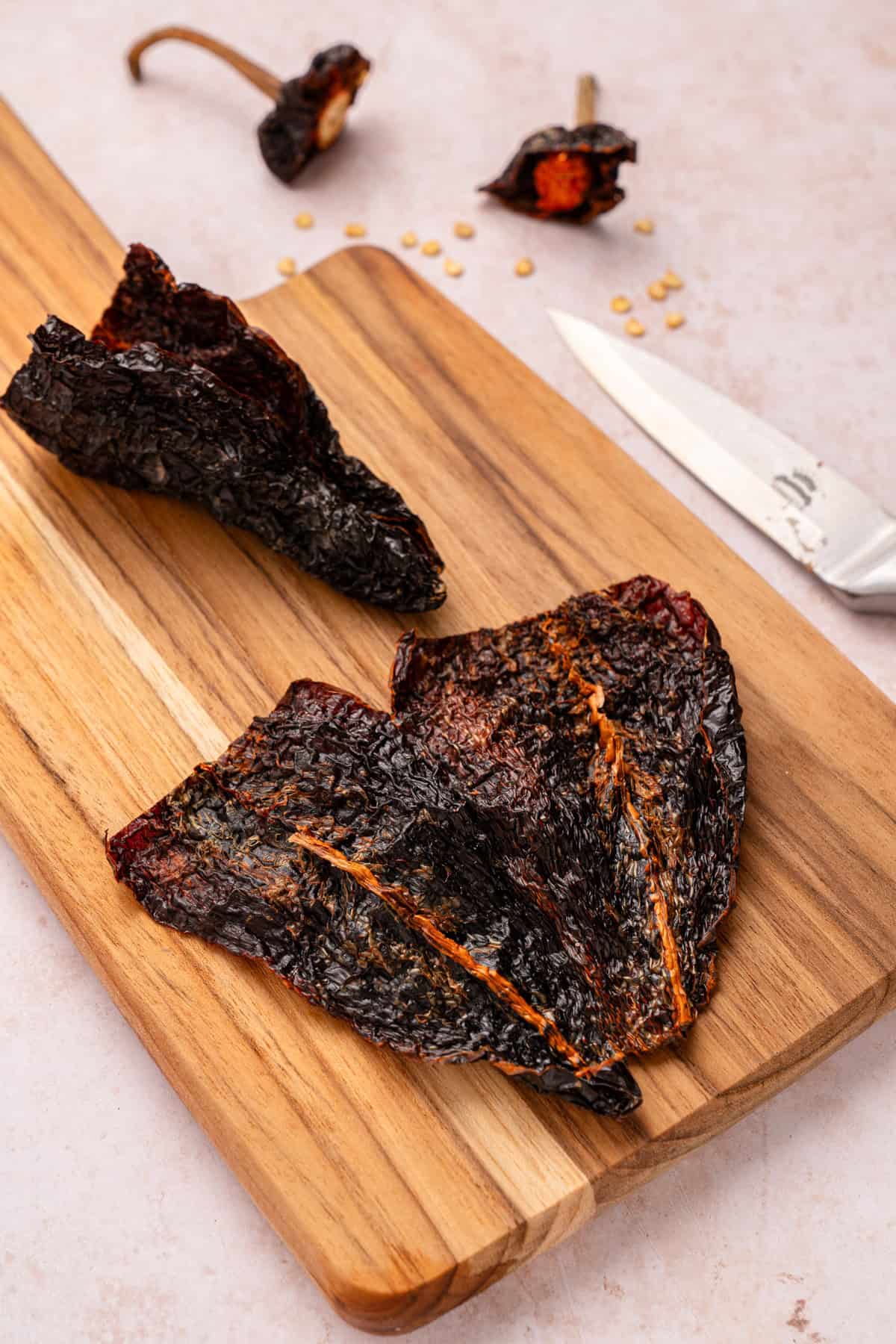 Cutting dried ancho chiles.