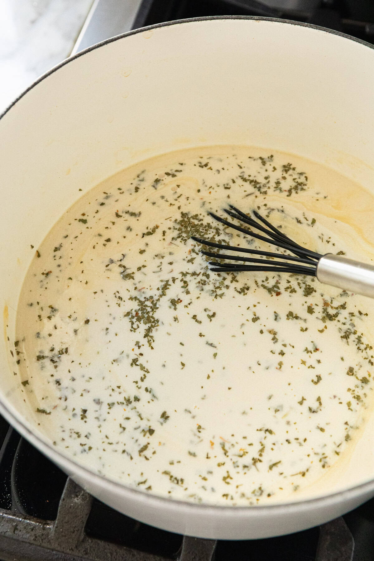 Adding heavy cream to make the sauce.