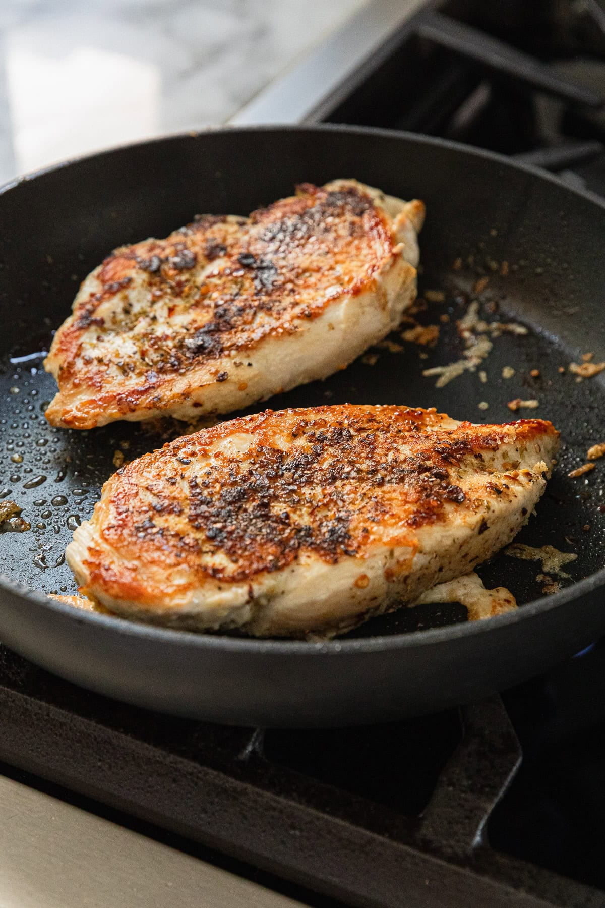 Cooking chicken breast in a skillet.