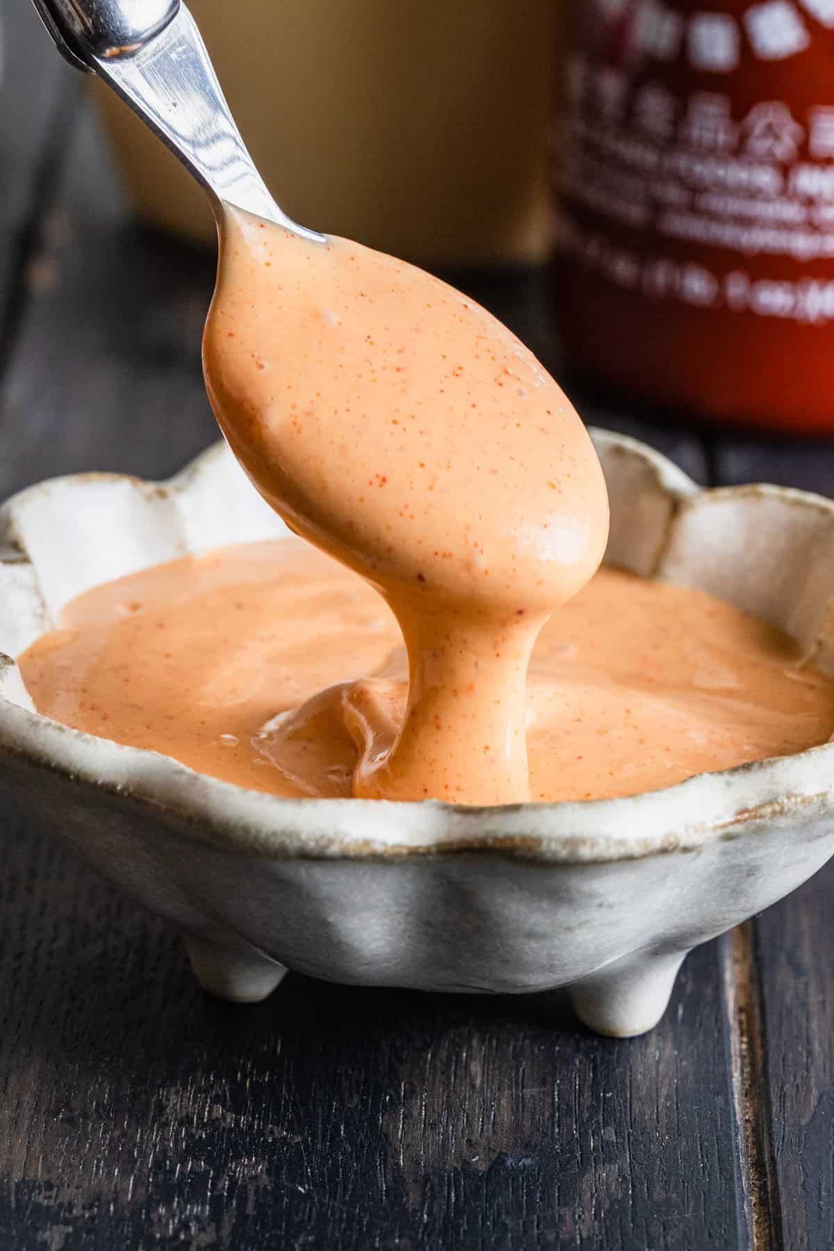 Pouring the sauce with a spoon.