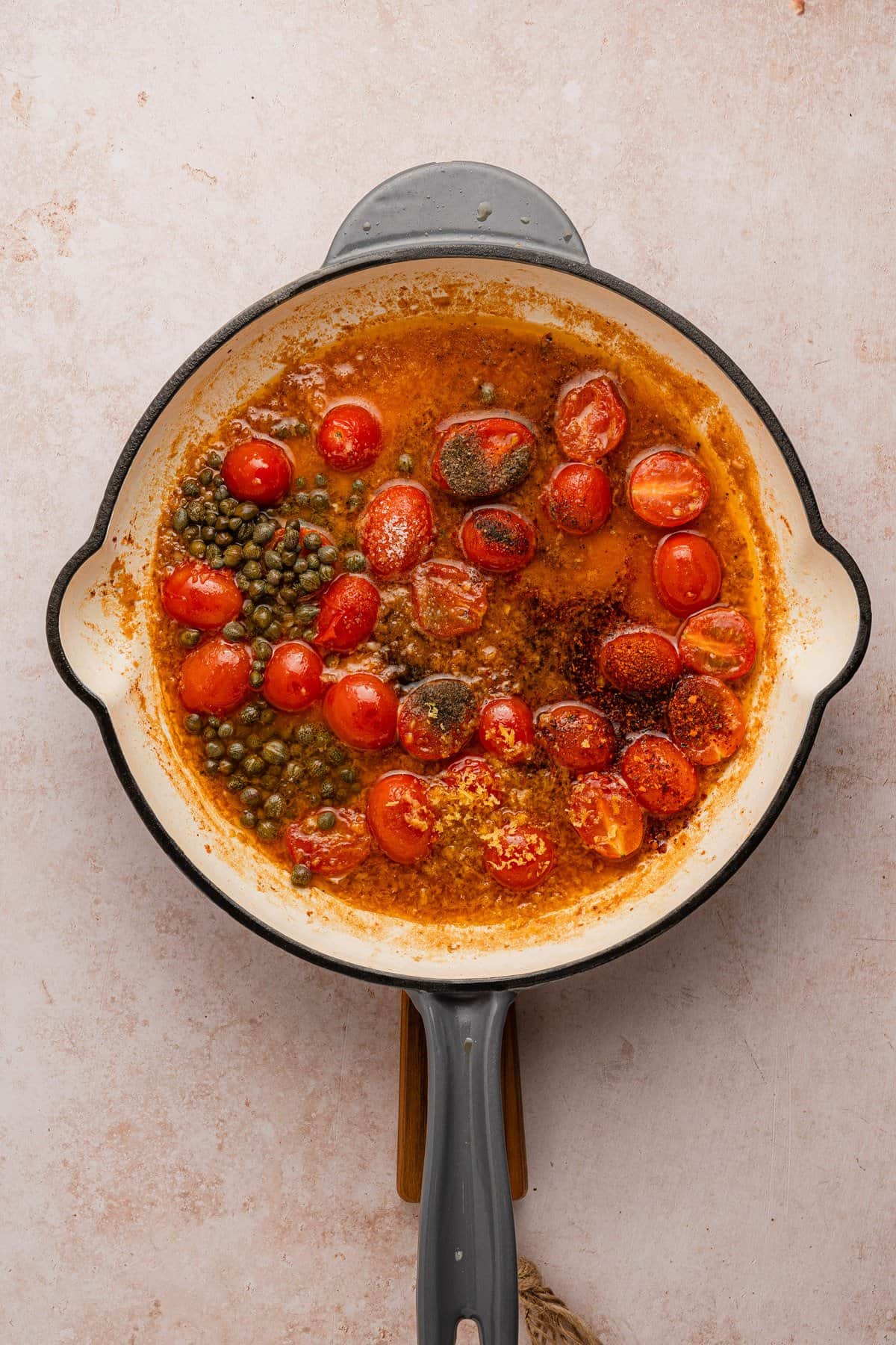 Making the white wine sauce with capers.
