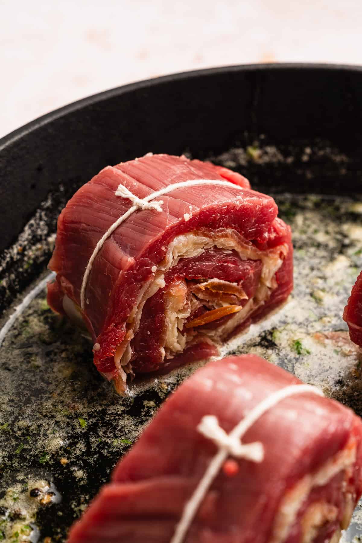 Searing pinwheels in garlic butter.