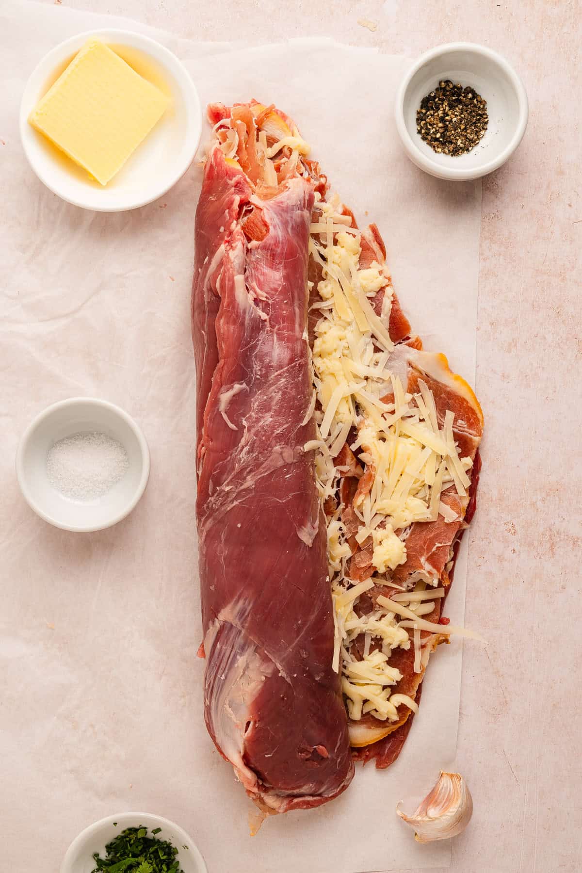 Rolling a piece of flank steak to form a pinwheel.