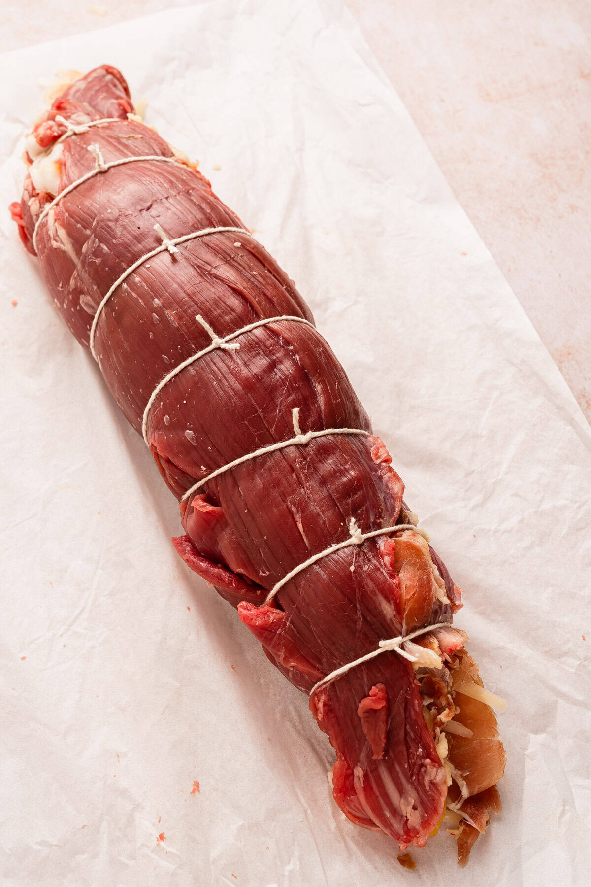 Beef flank steak rolled and tied with kitchen twine.