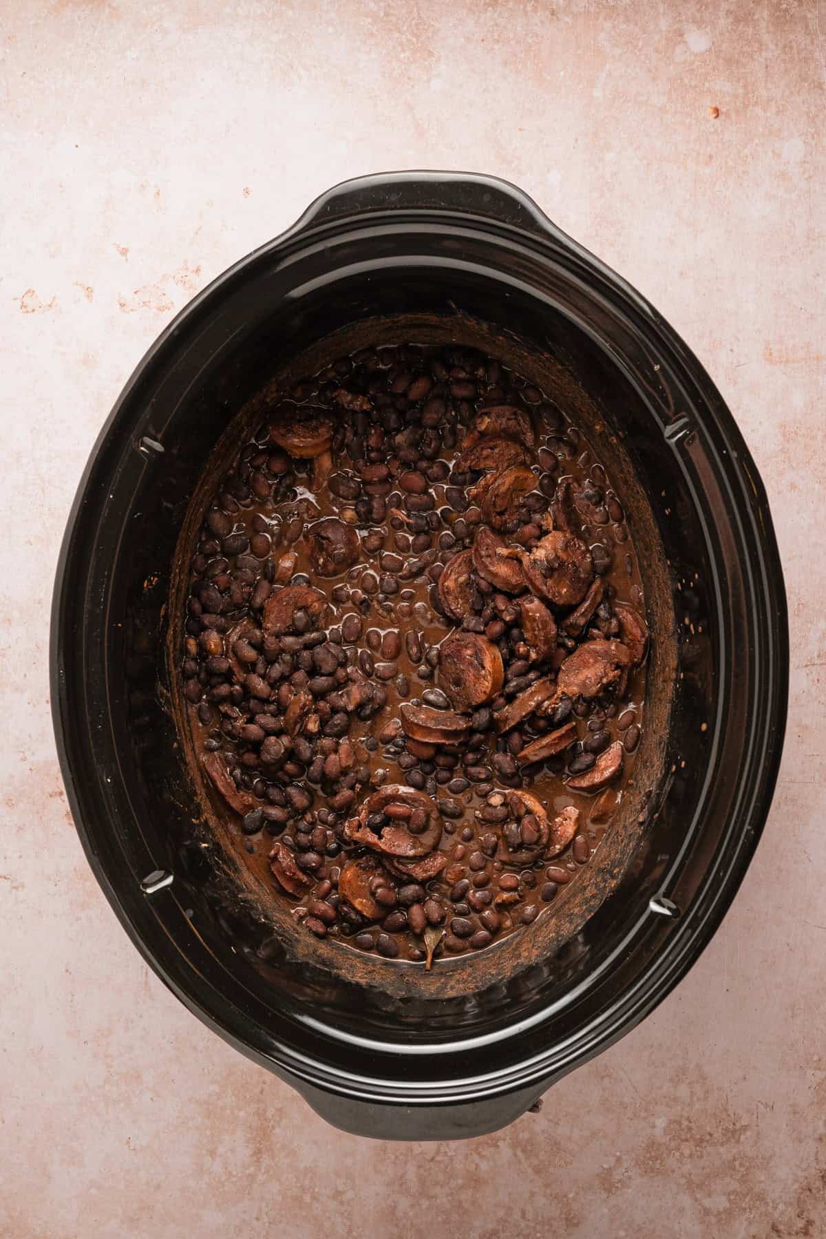 Tender beans and cooked choirzo in the crockpot.